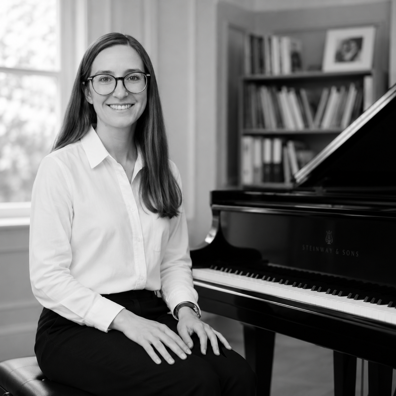 Portrait of Emma Leiuman seated beside her grand piano